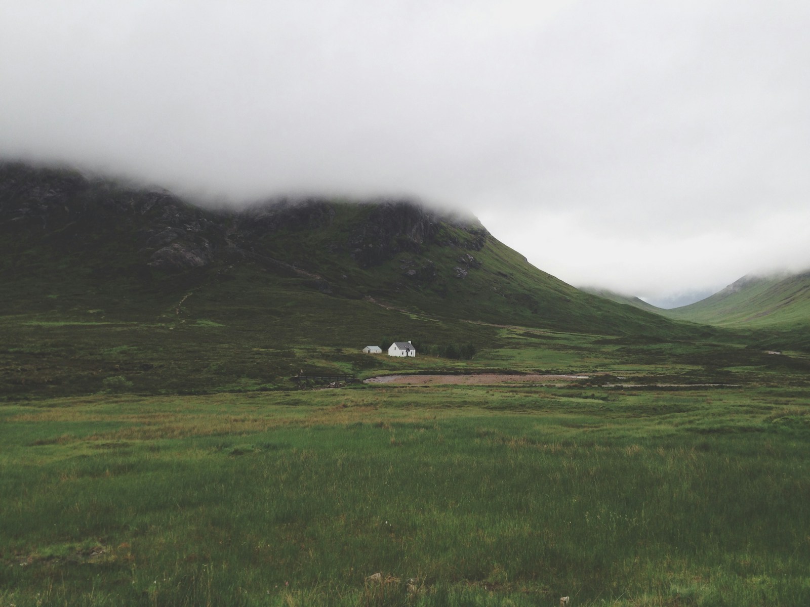 white wall paint house in green grass field